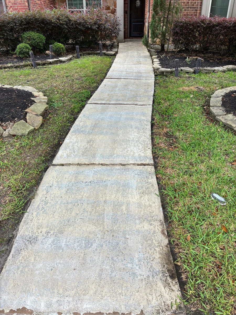 The same Katy, TX walkway after pressure washing — concrete blasted clean